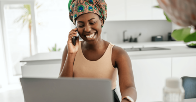 Person making political fundraising calls in front of a computer in a kitchen