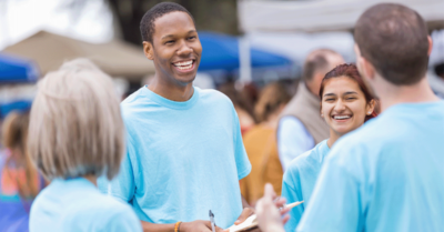 A picture of volunteers gathering ballot access signatures at an event