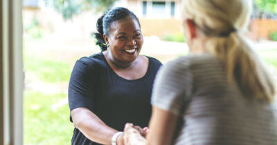 A political campaign volunteer engages with a voter through political persuasion