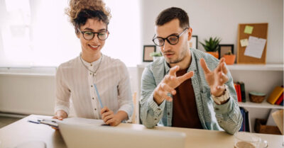 Political campaign planner working with a campaign consultant at a desk