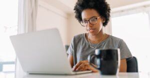 Someone sitting in front of a computer using a political texting service