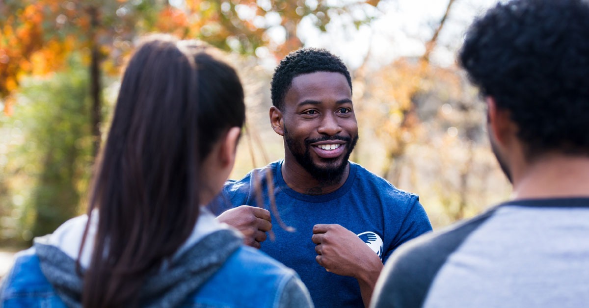 A campaign volunteer listens to a couple during a deep canvassing campaign.