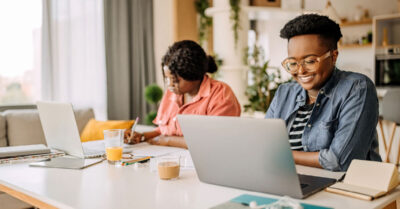 Fundraising-professionals-sit-at-their-computers-in-a-home-evaluating-their-political-fundraising-success