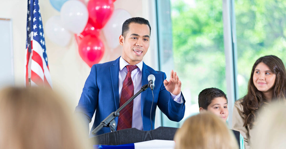 A candidate speaks at a podium about his political campaign strategies.