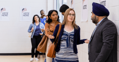 Voters talking at a polling location.