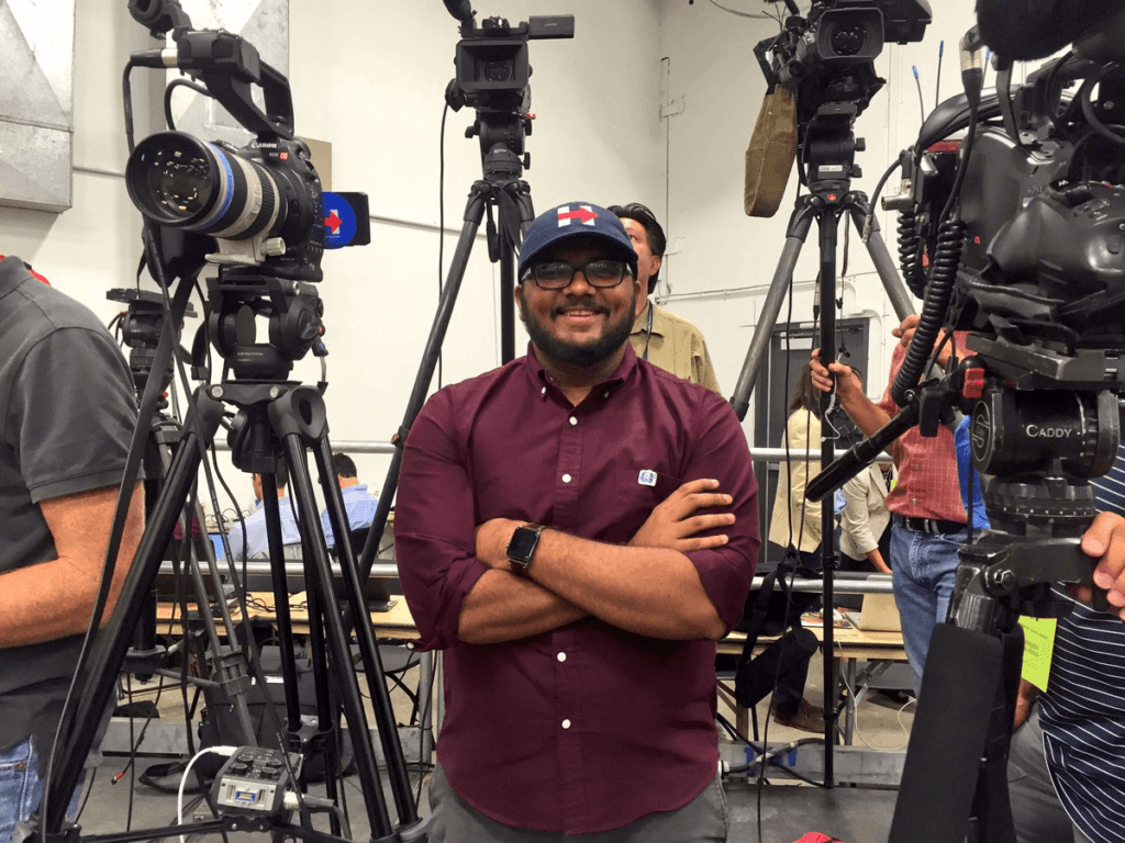 Progressive digital strategist Yash Mori stands in a film studio and explains how to make a campaign video.