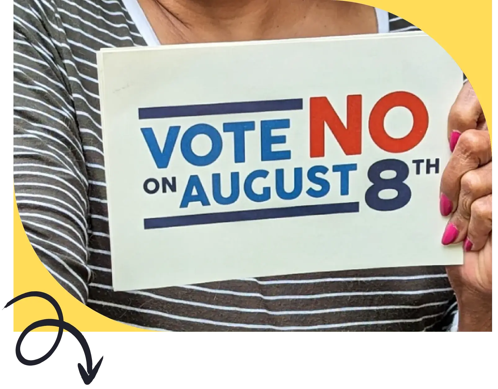 Person at rally holds a vote no on August 8th sign against issue 1 in Ohio special election 2023