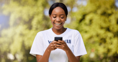 A campaign volunteer outside using the MiniVAN app for canvassing.