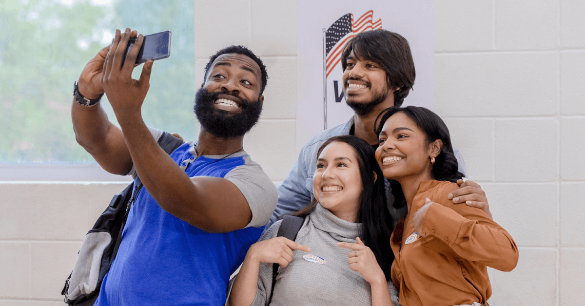 Campaign supporters take a selfie at their polling location to post as a part of their political campaign social media strategy.