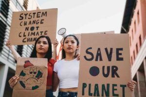 Two women hold signs as they march in a protest during a grassroots political campaign.