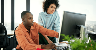 Political consultants plan a political advertising campaign on a work computer in an office.