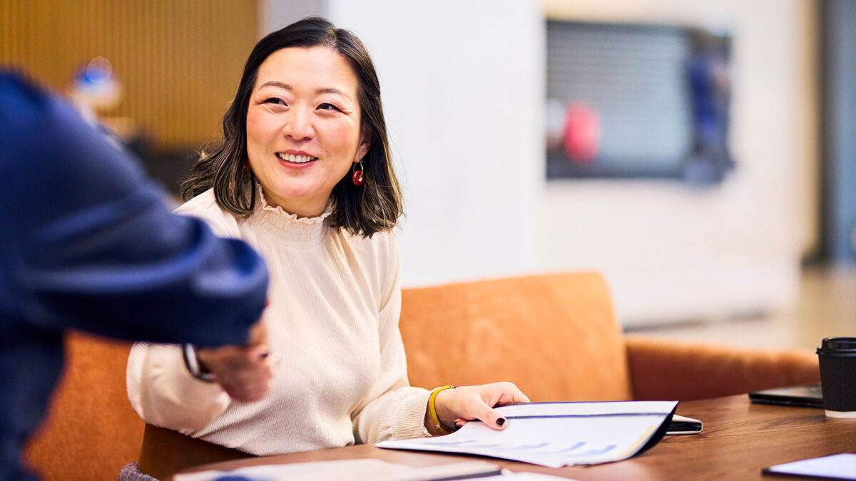 Two colleagues greeting each other during a campaign meeting, representing collaboration and planning.