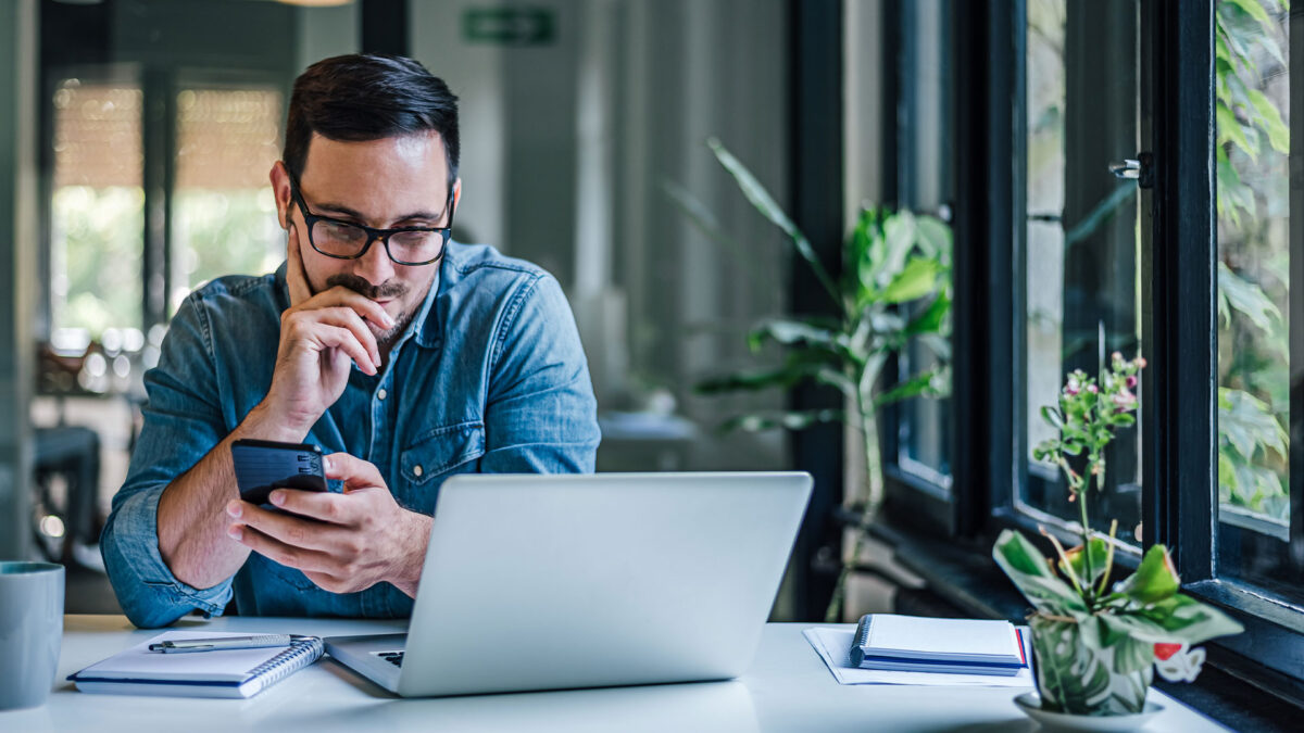 Local campaign fundraiser reviewing donor information on laptop during call time.