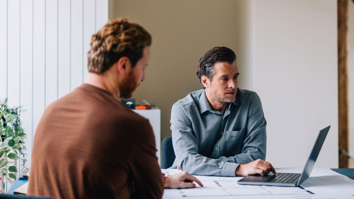 Two people reviewing NGP fundraising metrics on a laptop.