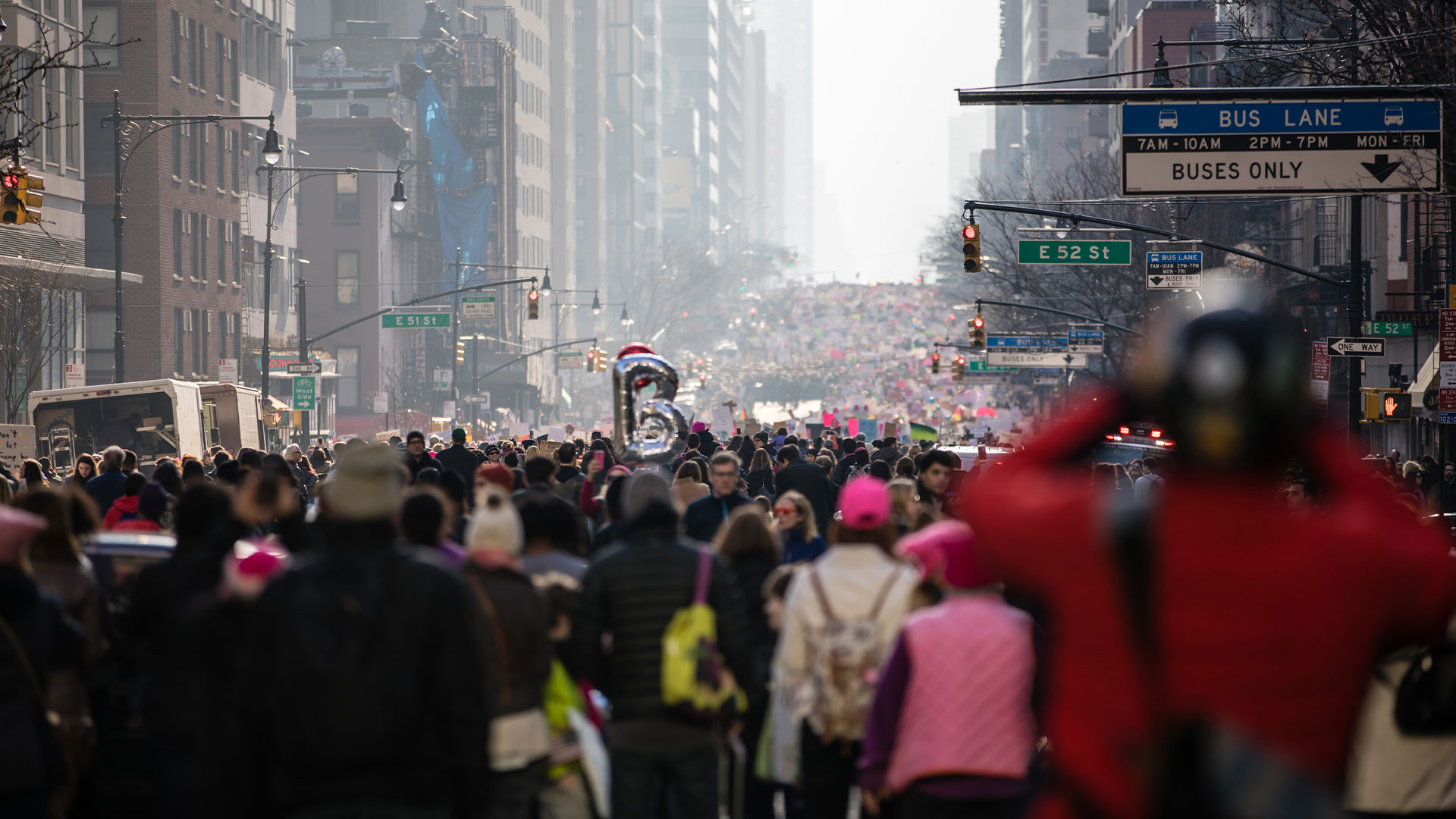 A large scale protest with thousands of protestors marching on the street