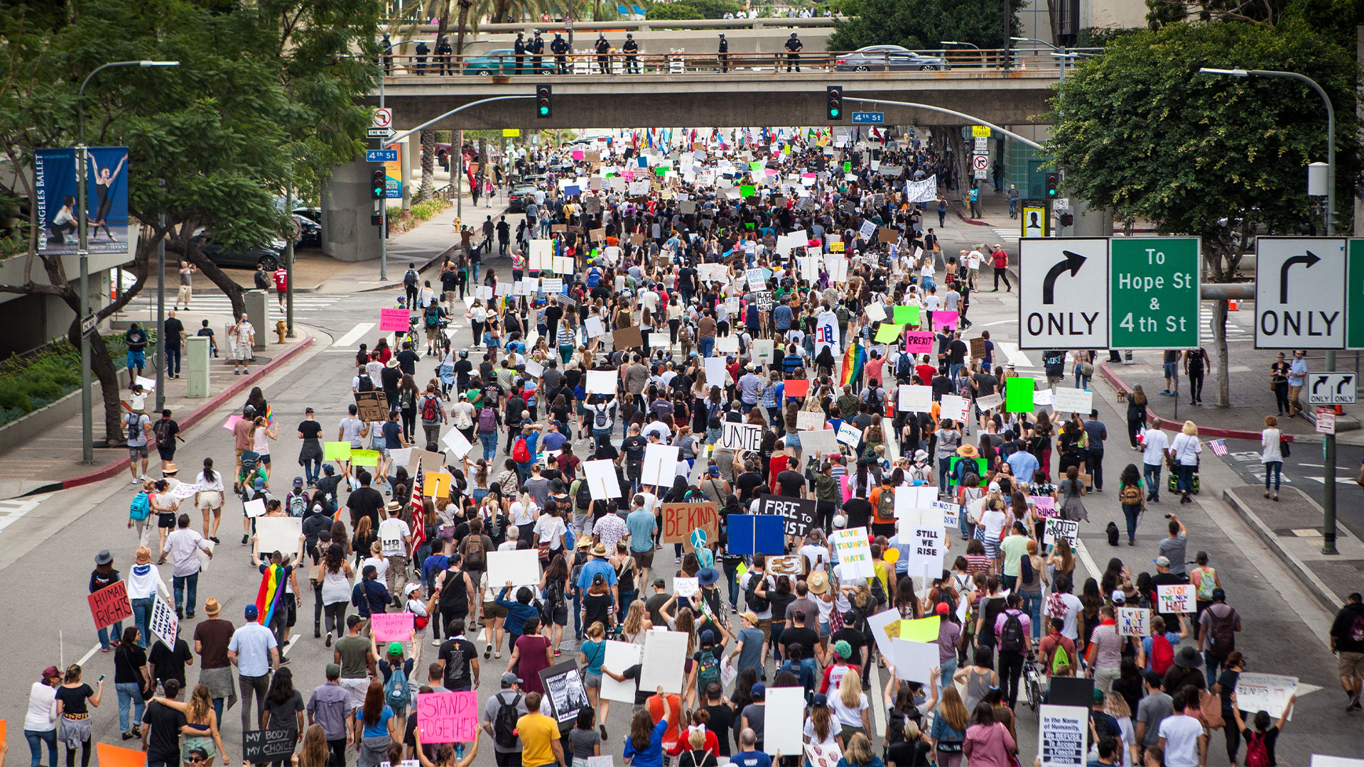 A large protest with hundreds of protestors marching on the street