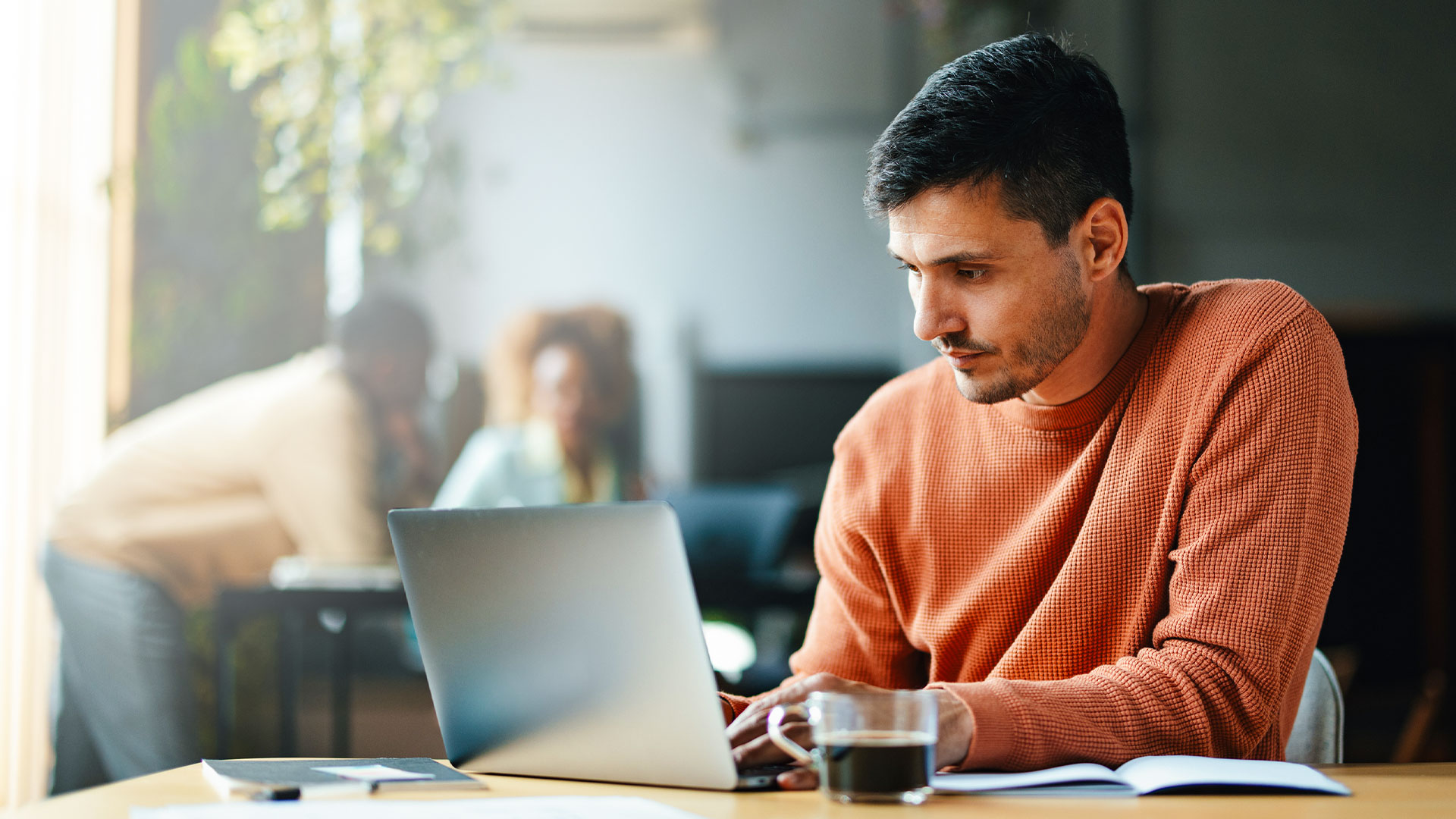 A person working in ActionKit sitting at a desk in a modern workspace.