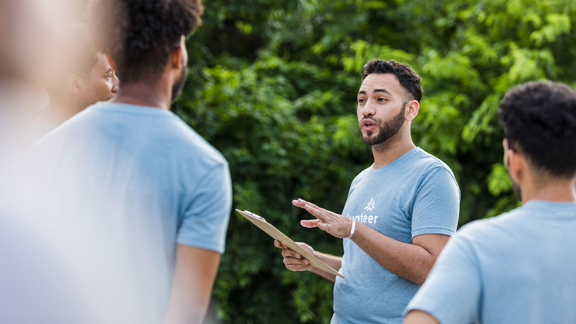 A volunteer holds a clipboard of voter file information