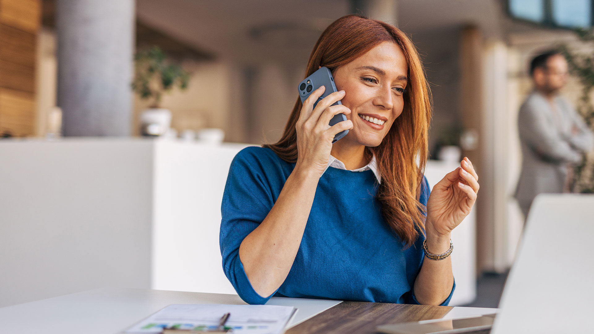 A woman talking on the phone at home