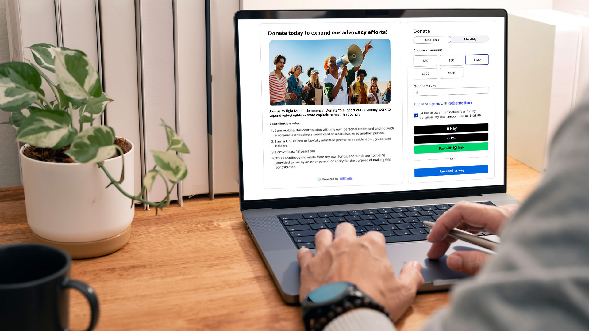 A person typing on a laptop showing an NGP VAN Payments form