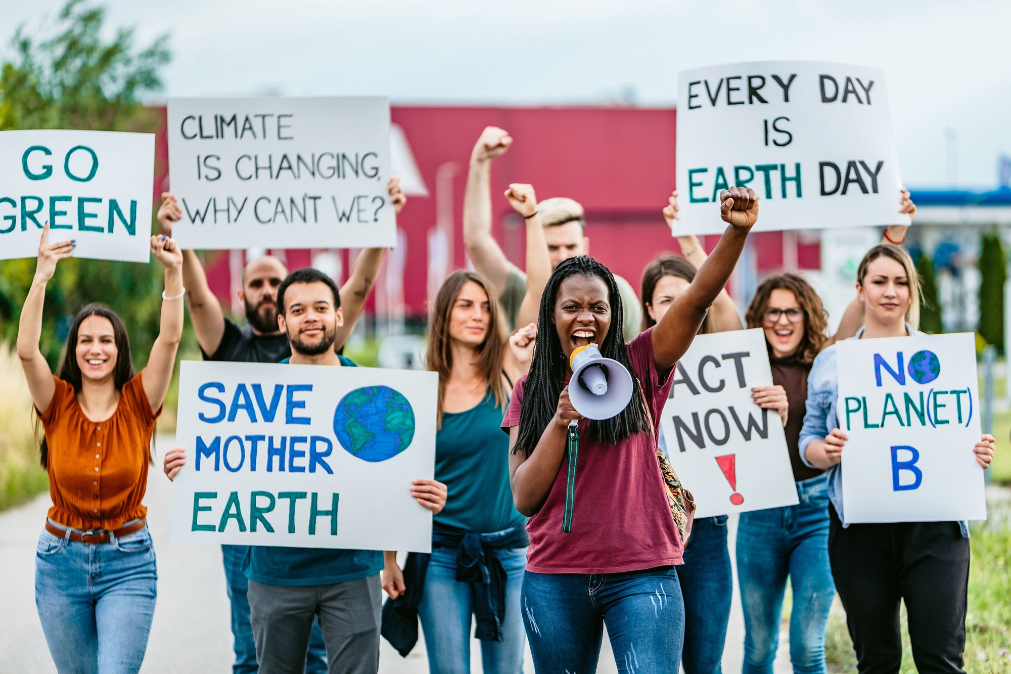 A group of environmental justice protestors with signs