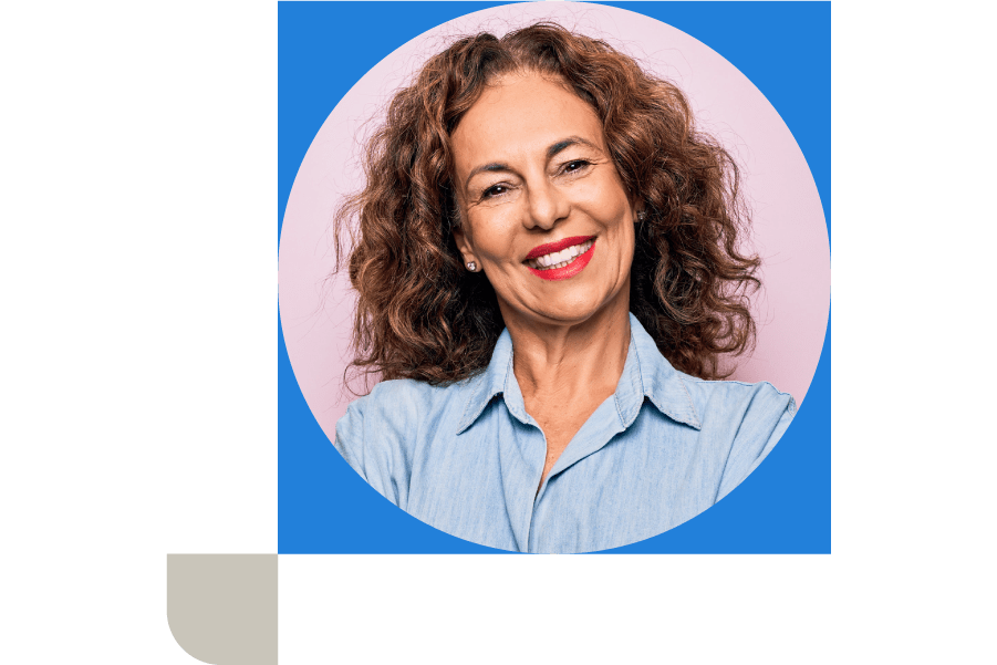 A woman smiling at the camera in a blue shirt on a pink background
